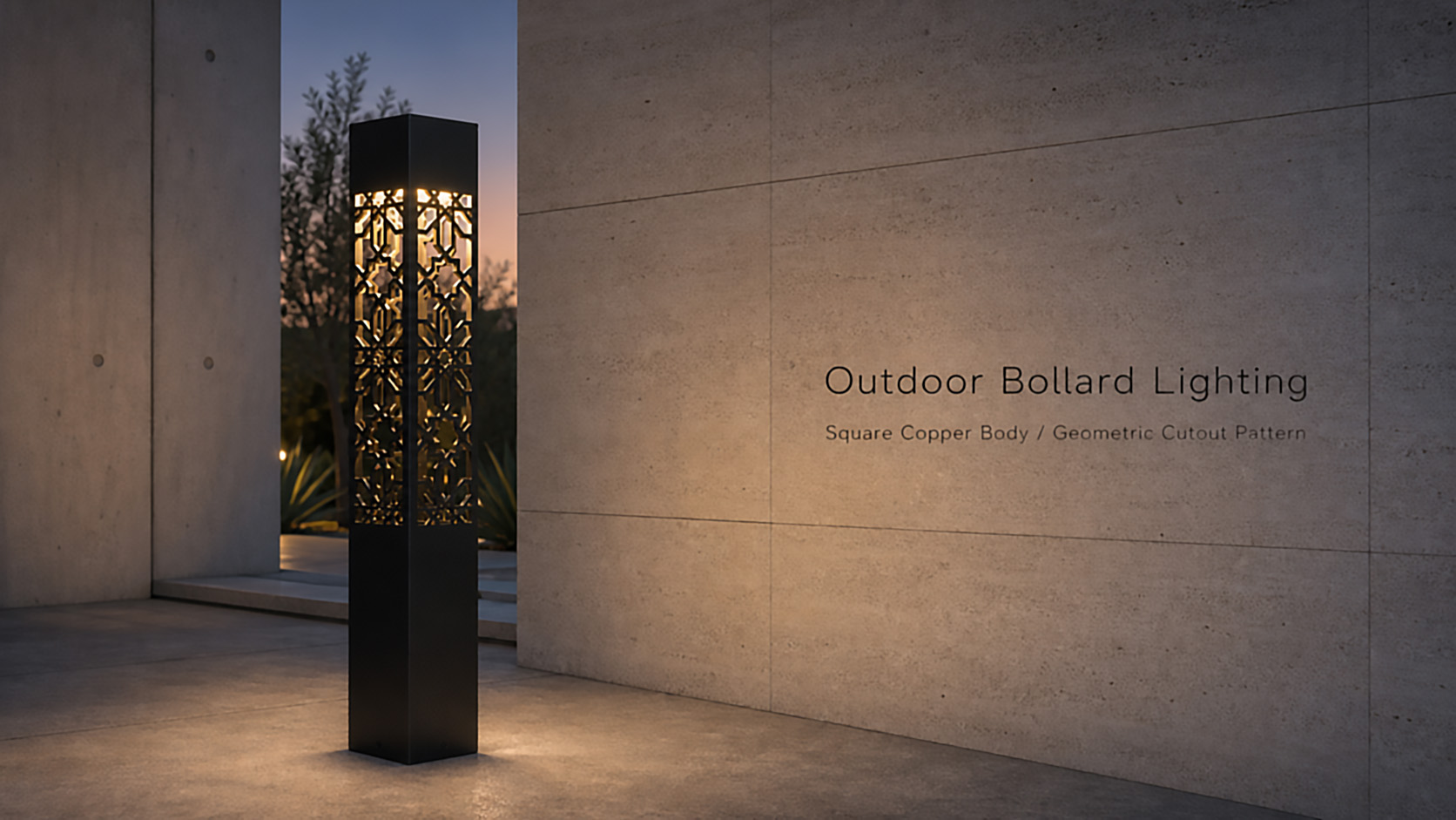 Black square outdoor bollard light with intricate geometric patterned cutouts, illuminated from within, standing on a concrete pathway beside a textured concrete wall at dusk.