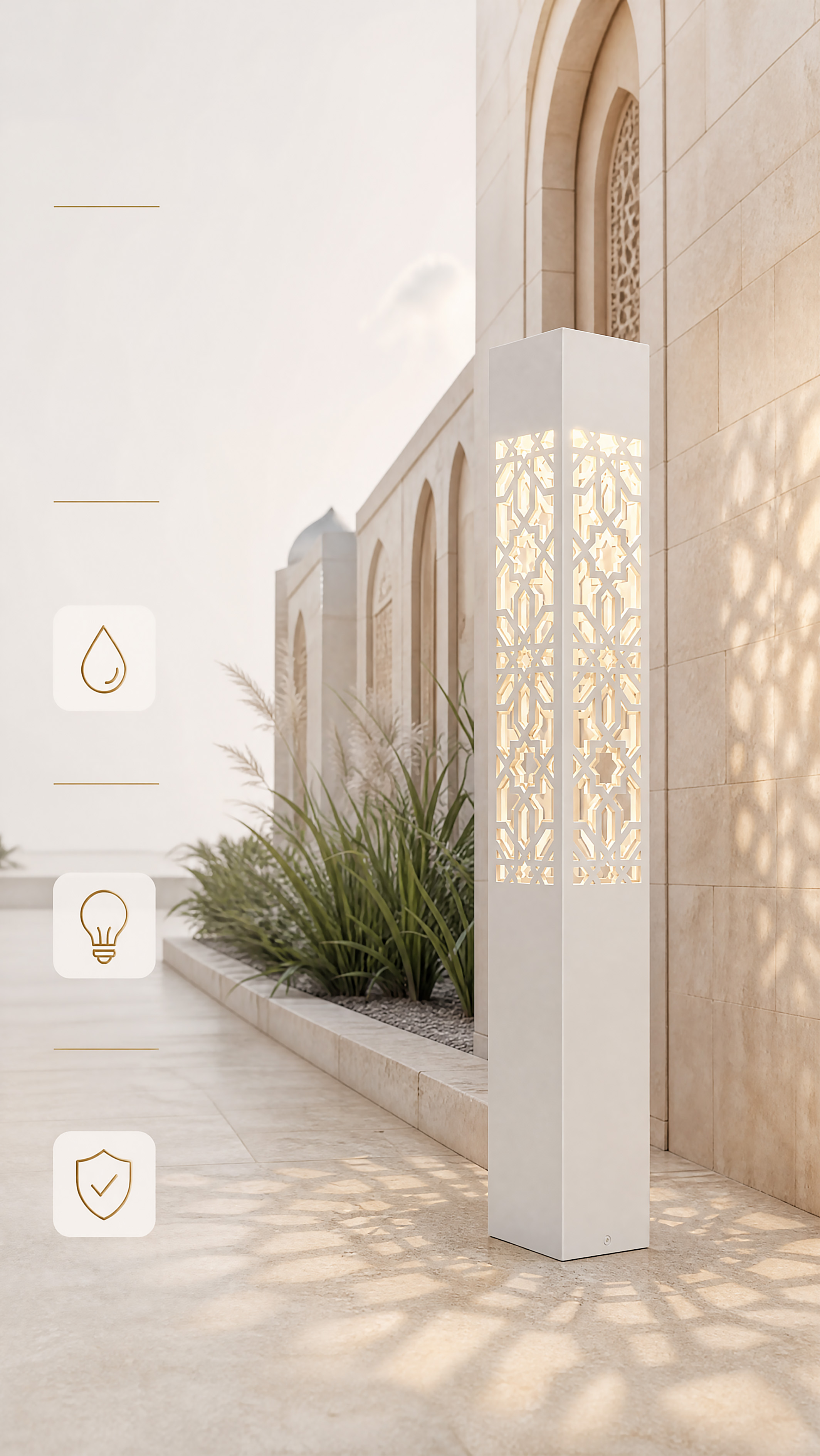A modern white geometric bollard light with a laser-cut Arabic pattern, illuminating a pathway next to a light stone building and lush green plants.